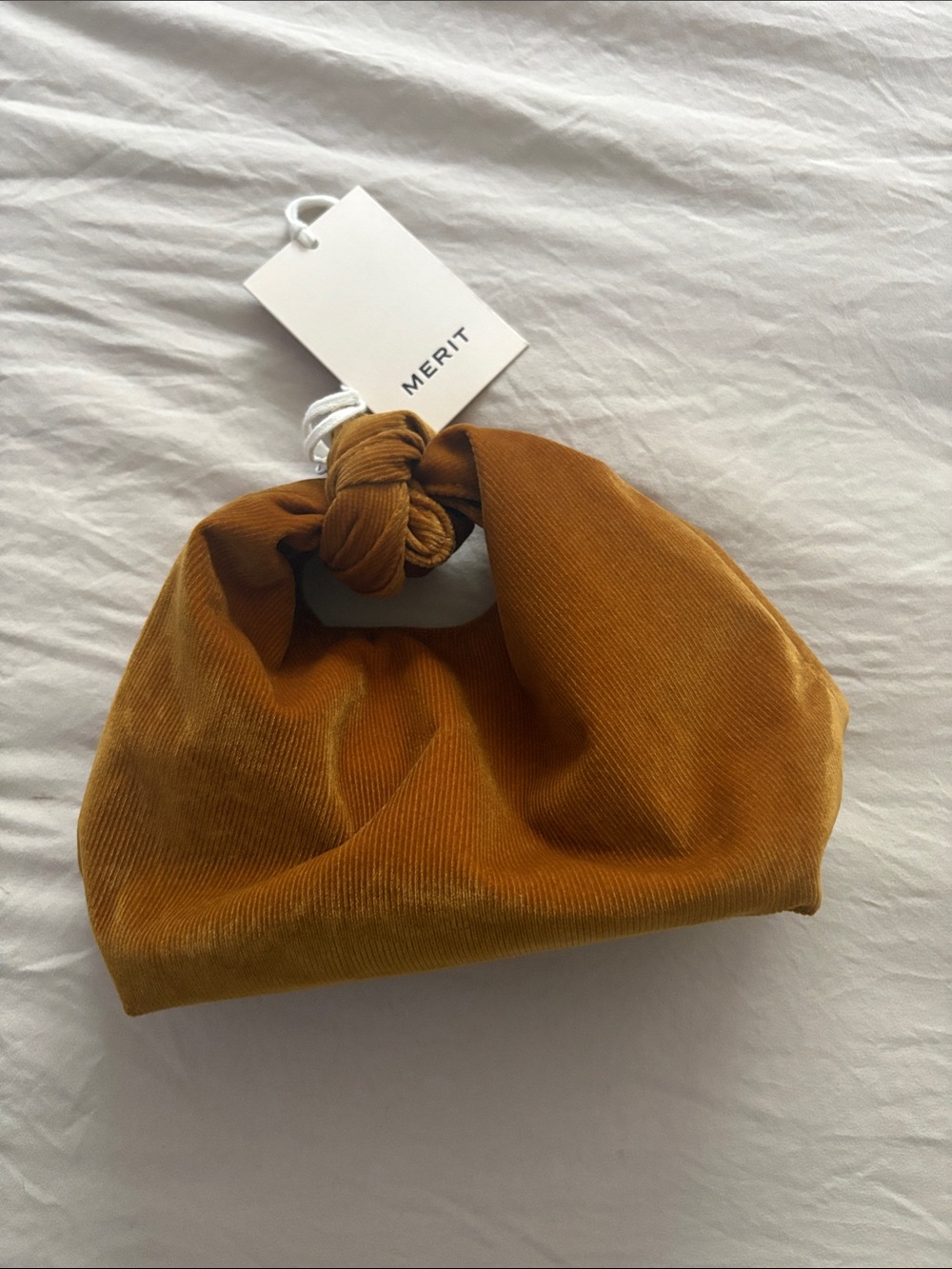Merit Mini Knot Wristlet Bag in Mustard